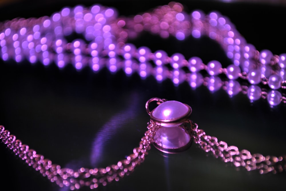 a close up of a necklace on a table