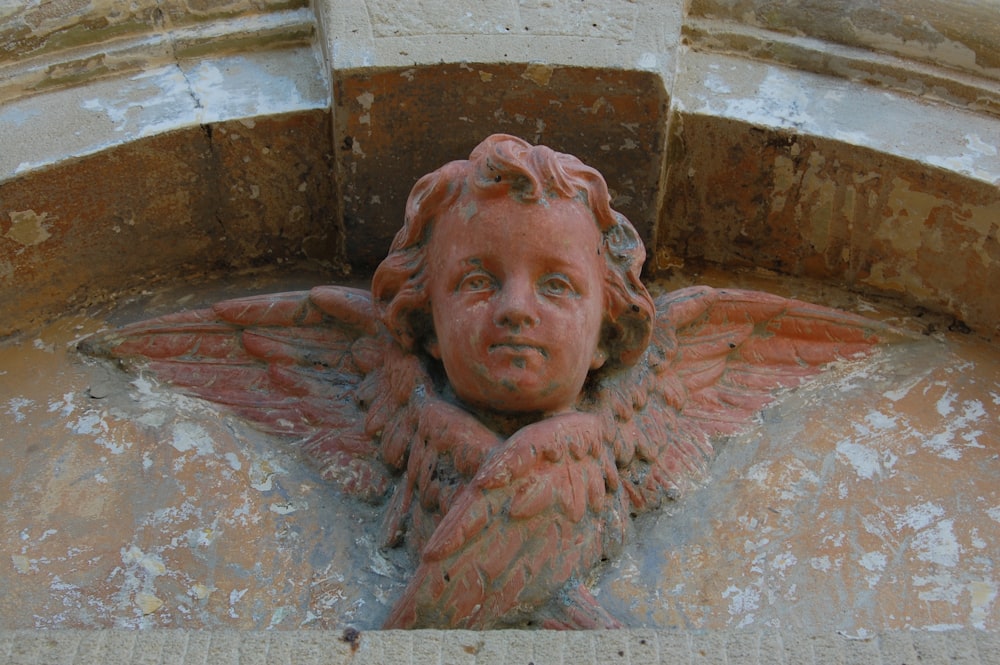 a close up of a statue of an angel on a building