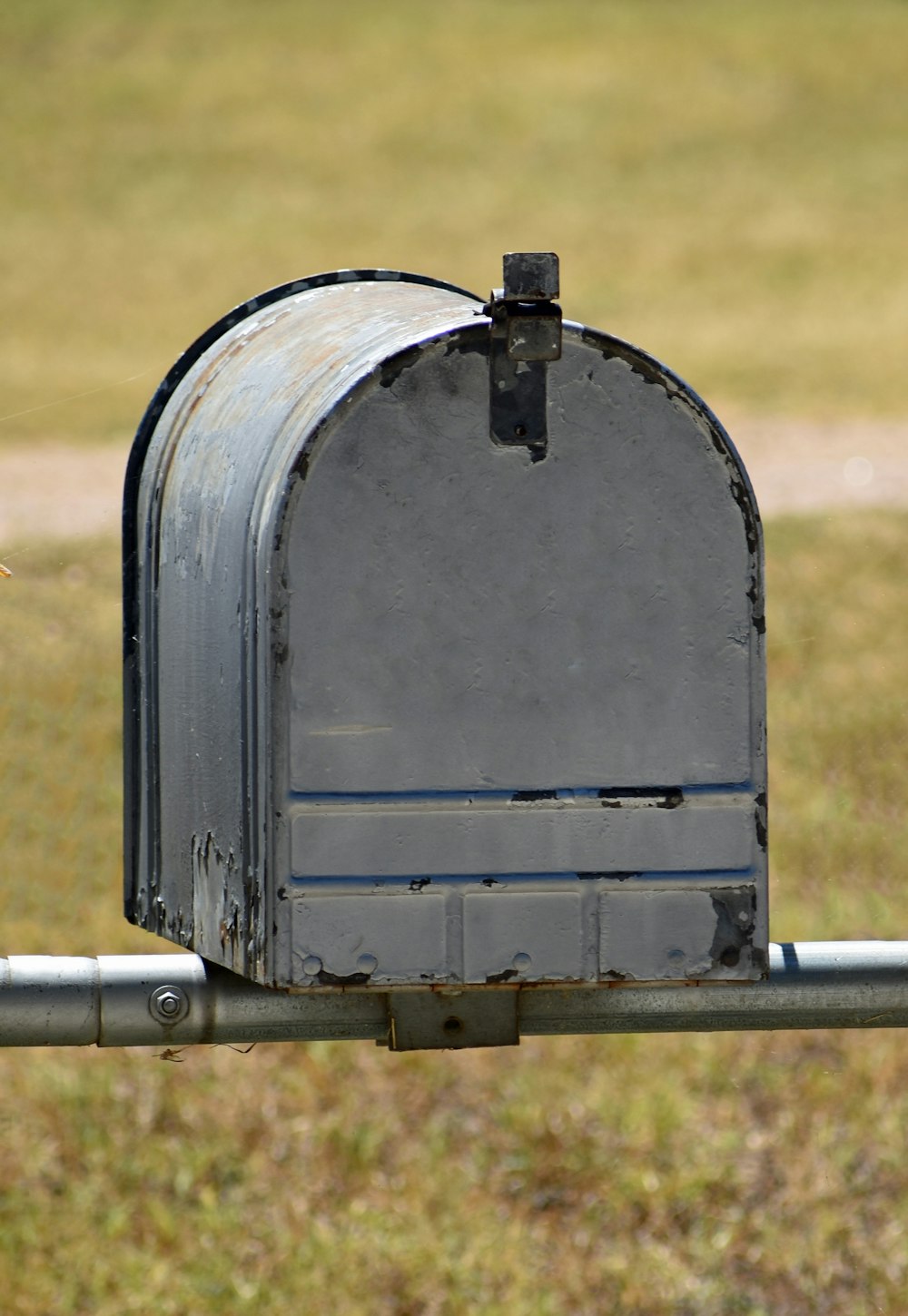 un buzón sentado encima de un poste de metal