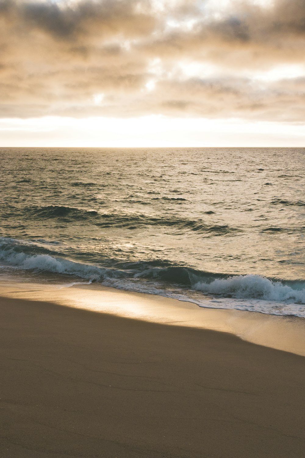 a beach with waves coming in to shore