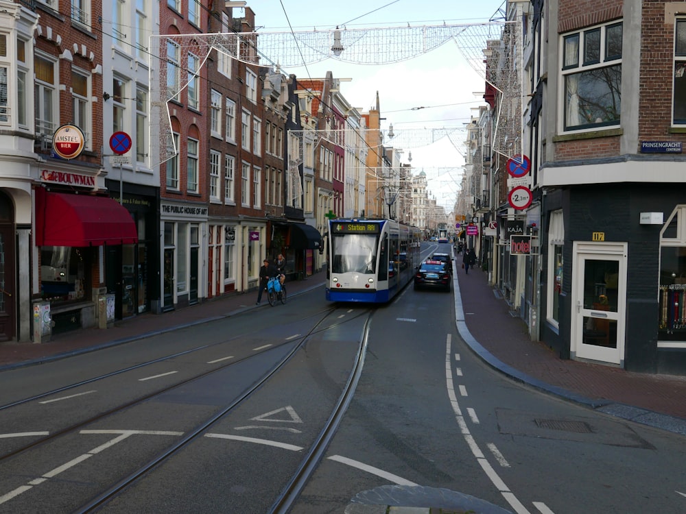 a trolley on a city street with buildings in the background