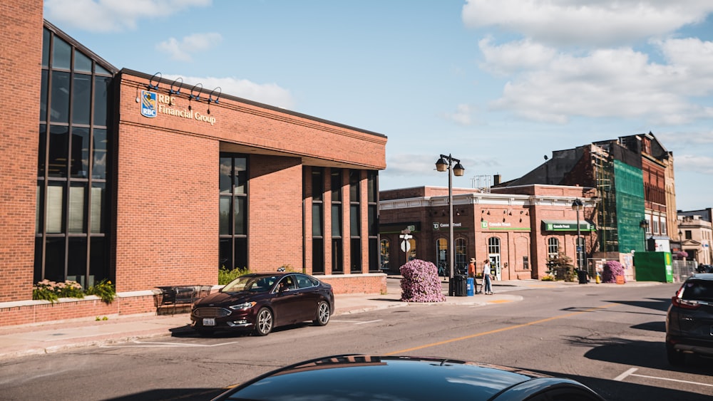 a car parked on the side of a road next to a building