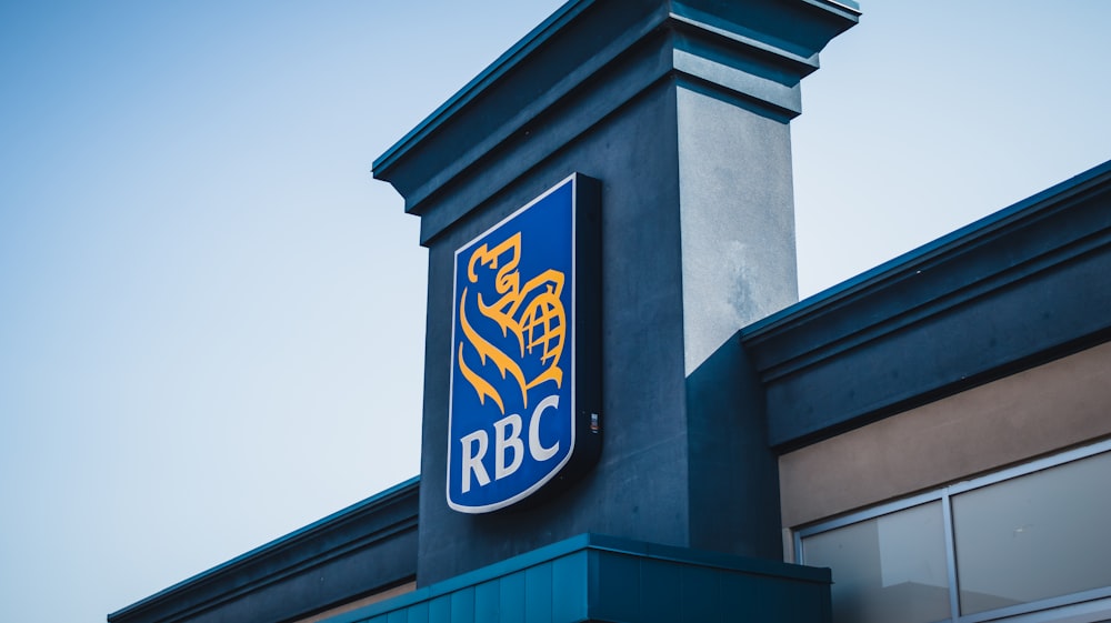 a blue and yellow sign on the side of a building