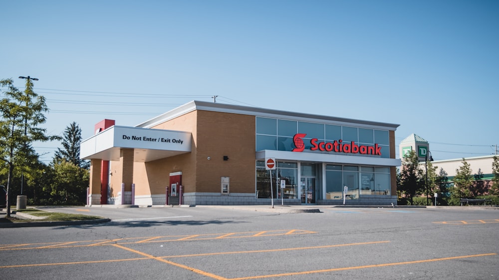 a store front with a parking lot in front of it