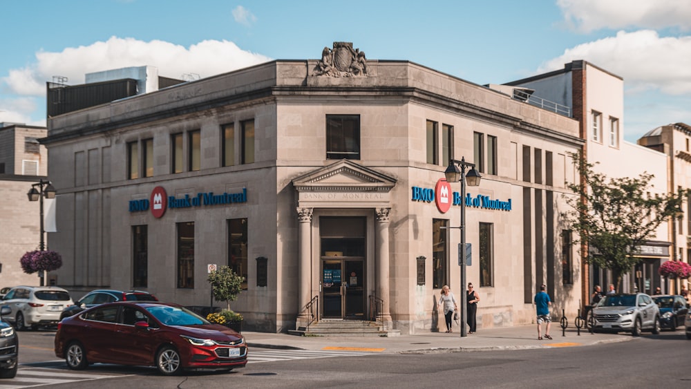 a red car is parked in front of a building