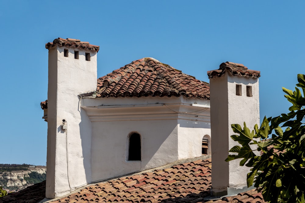 a white building with a red tiled roof