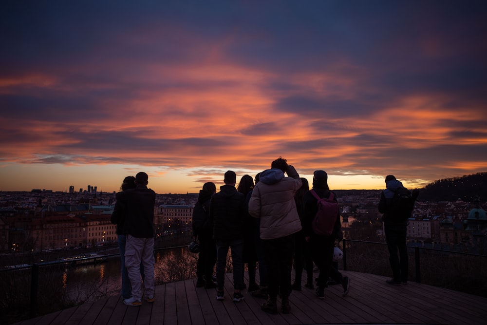 a group of people standing on top of a wooden platform