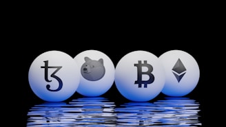 Four spherical objects are placed on a reflective surface with a black background. Each sphere has a cryptocurrency symbol: Tezos, Dogecoin, Bitcoin, and Ethereum. The spheres emit a blue glow, reflecting off the surface below.