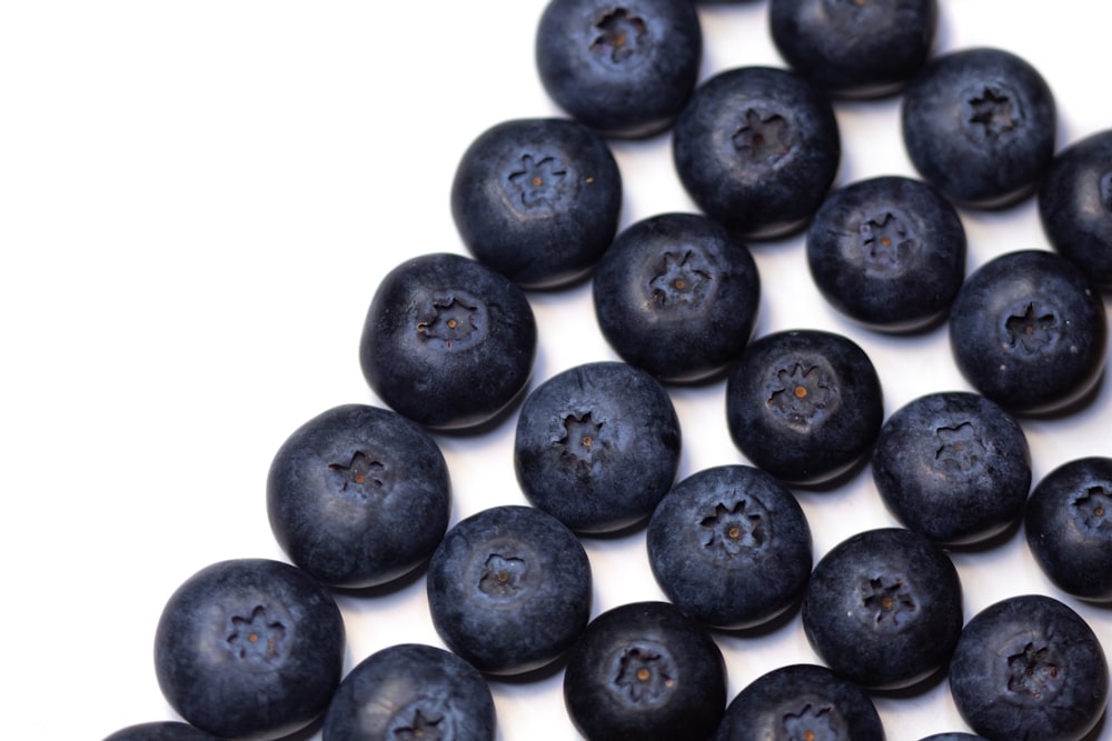 a pile of blueberries sitting on top of a white table