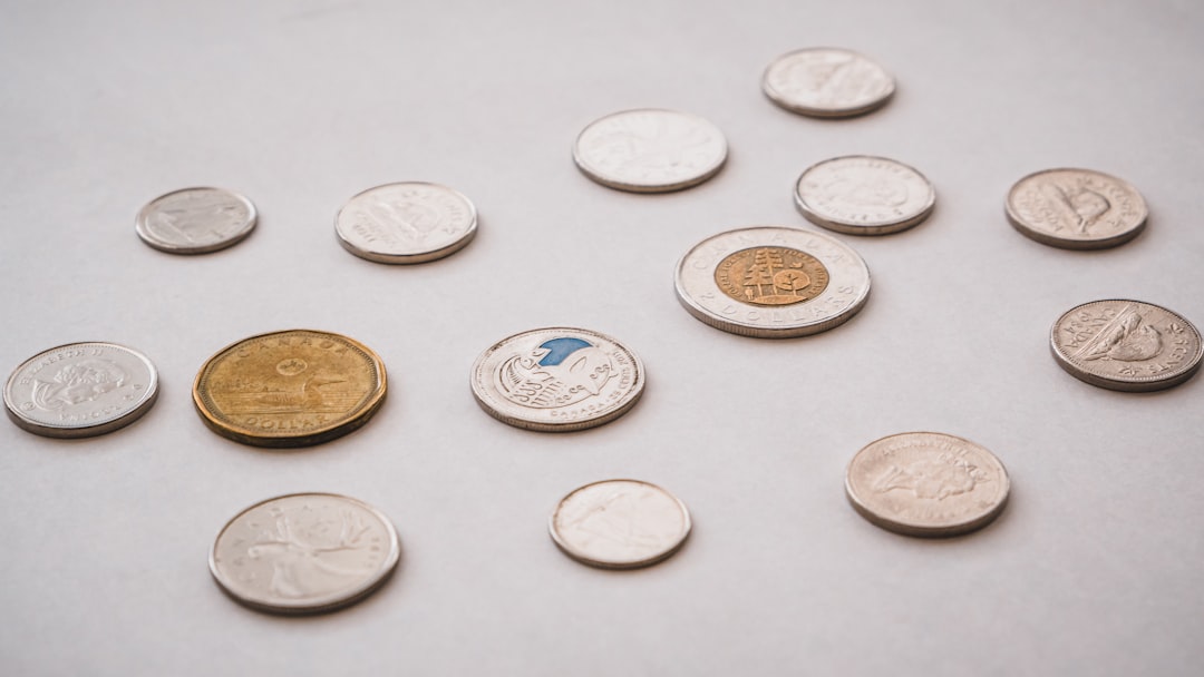 a bunch of different types of coins on a table, Canadian Coins