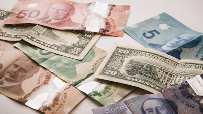 a pile of canadian money sitting on top of a table