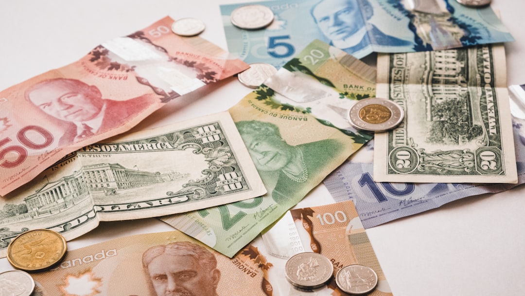 a pile of money sitting on top of a table, Canadian and American Money (coins and bills)</p>
<p>