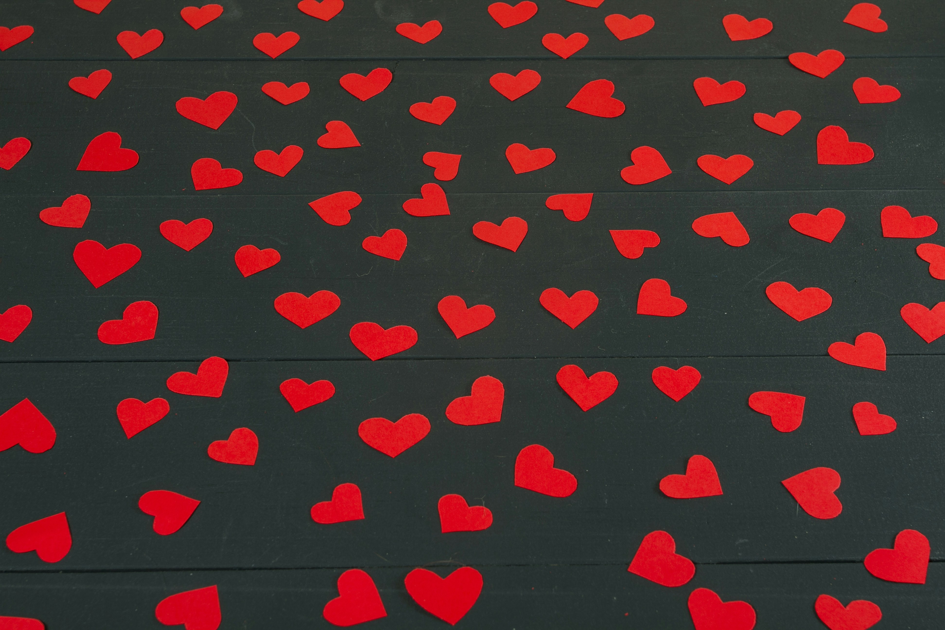 a bunch of red hearts on a black background