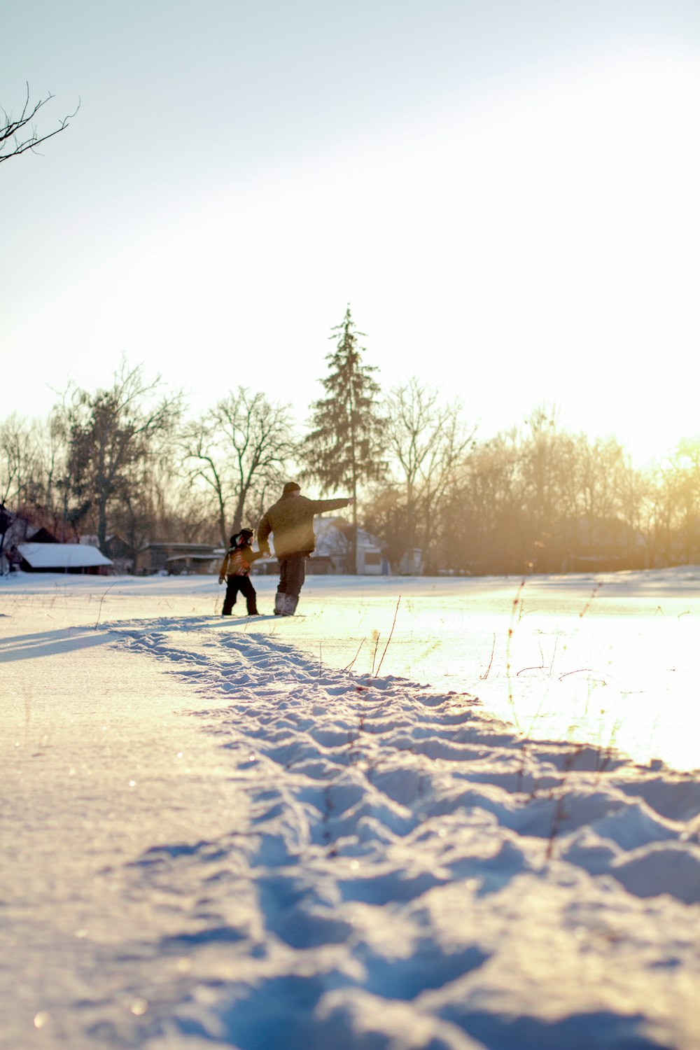 a person walking in the snow with a snowboard