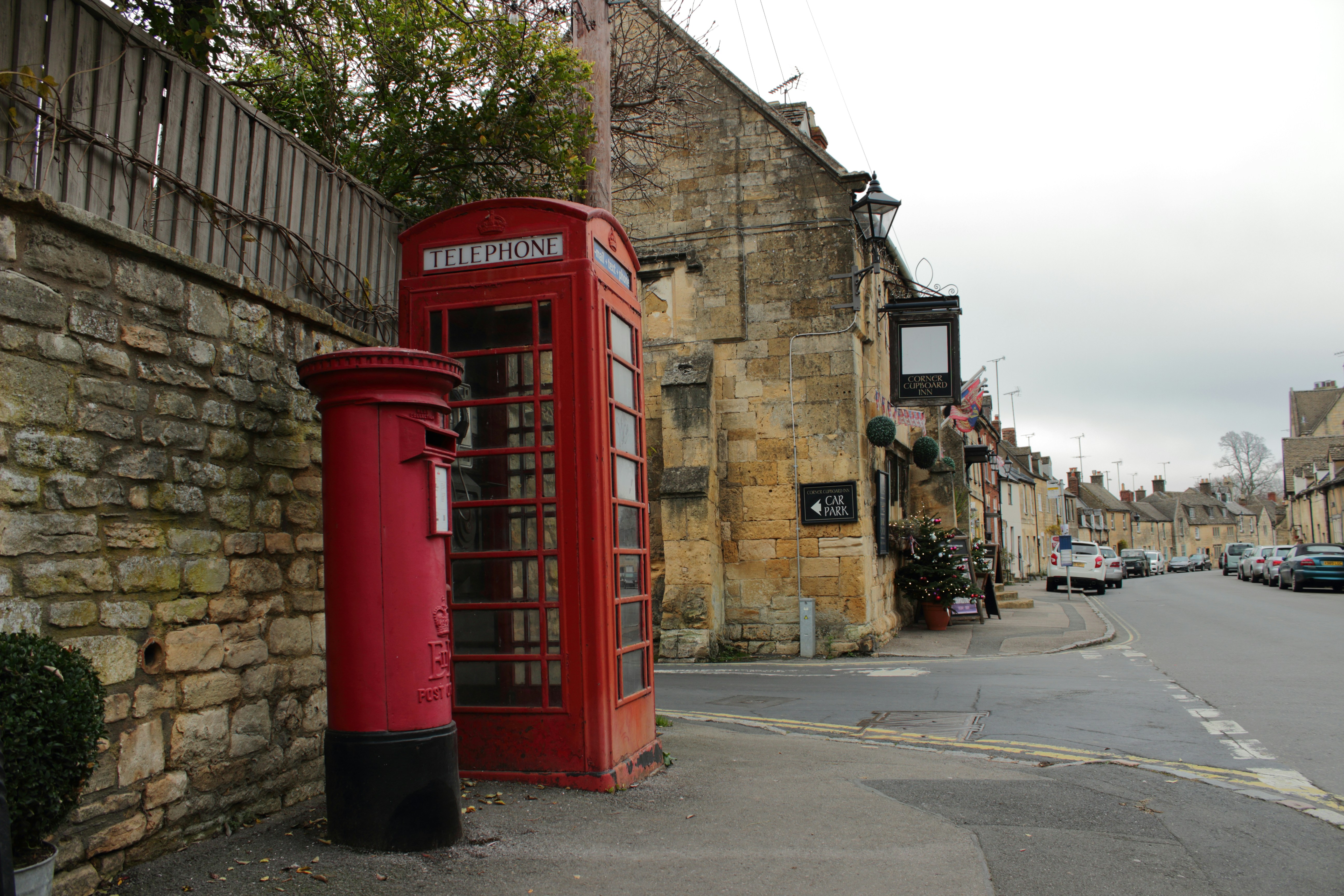 道路脇に座っている赤い電話ボックス