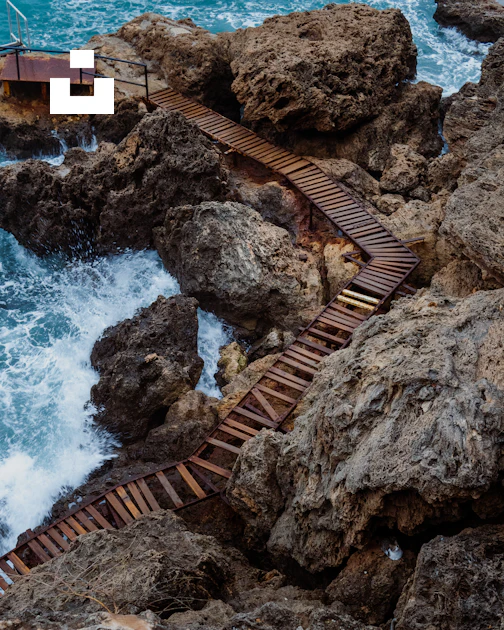 Walk Over Rocks A wooden walkway going over rocks into the ocean photo – Free Fener ...