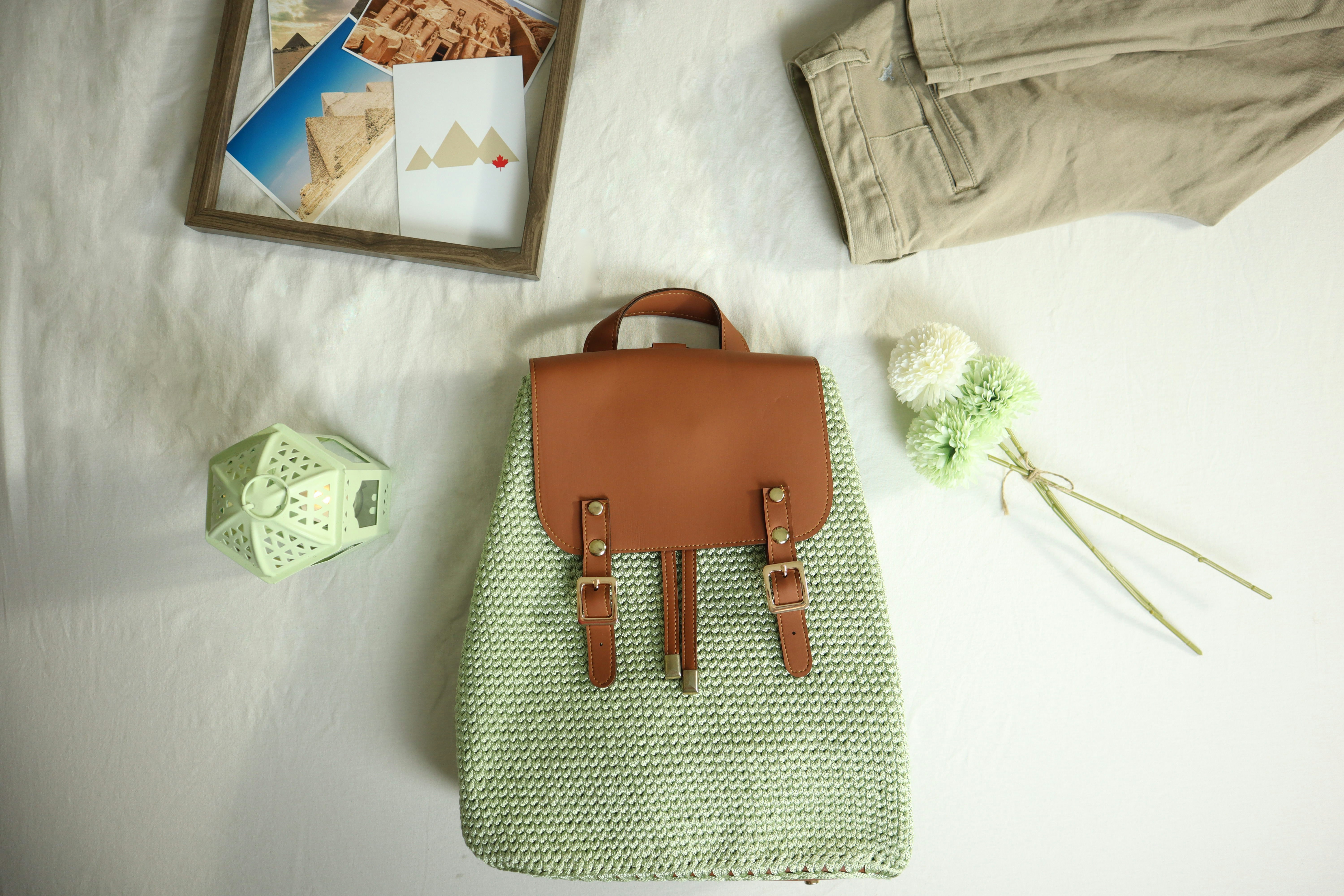 a purse sitting on top of a table next to a picture