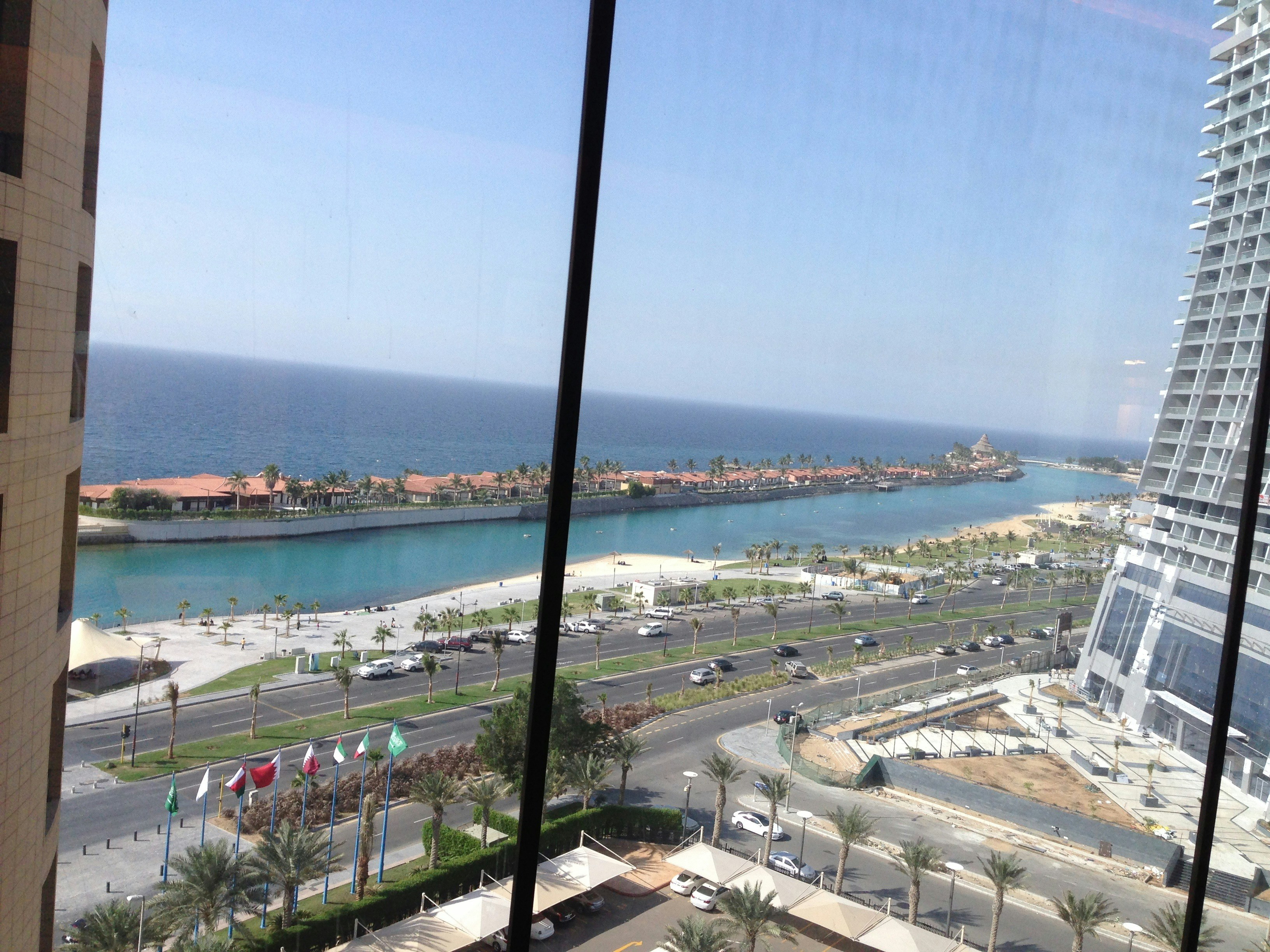 a view of the ocean from a high rise building, 