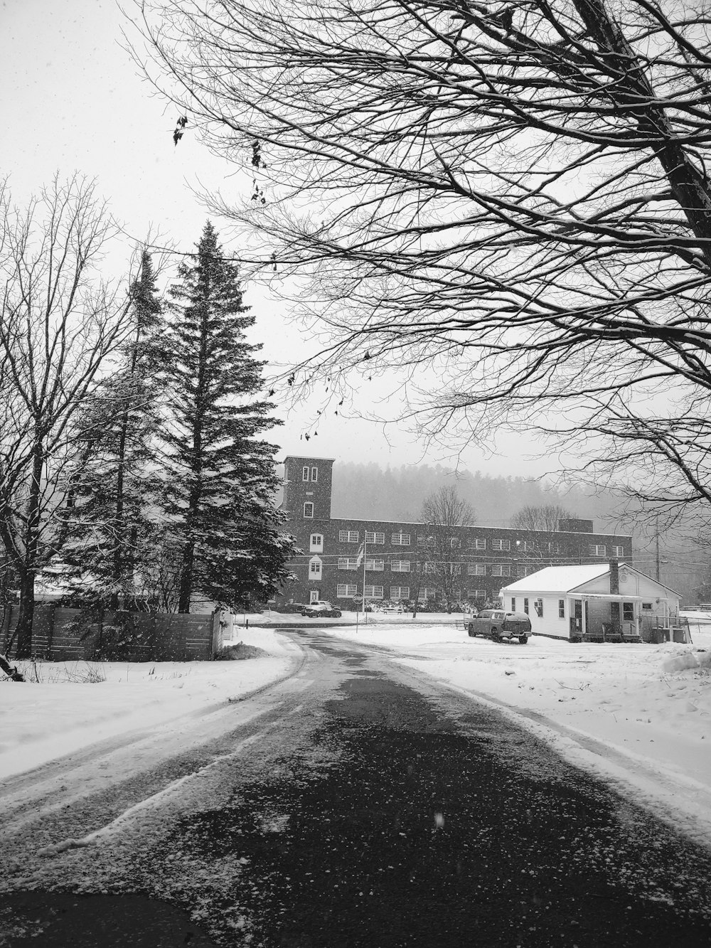 a black and white photo of a snowy road