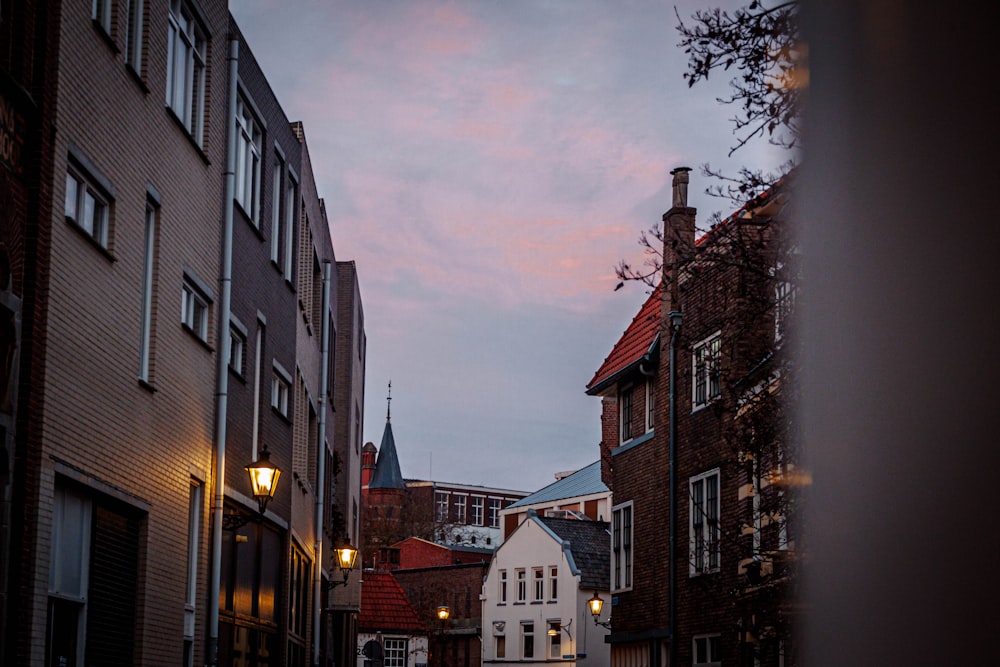 a city street with buildings and a clock tower in the distance