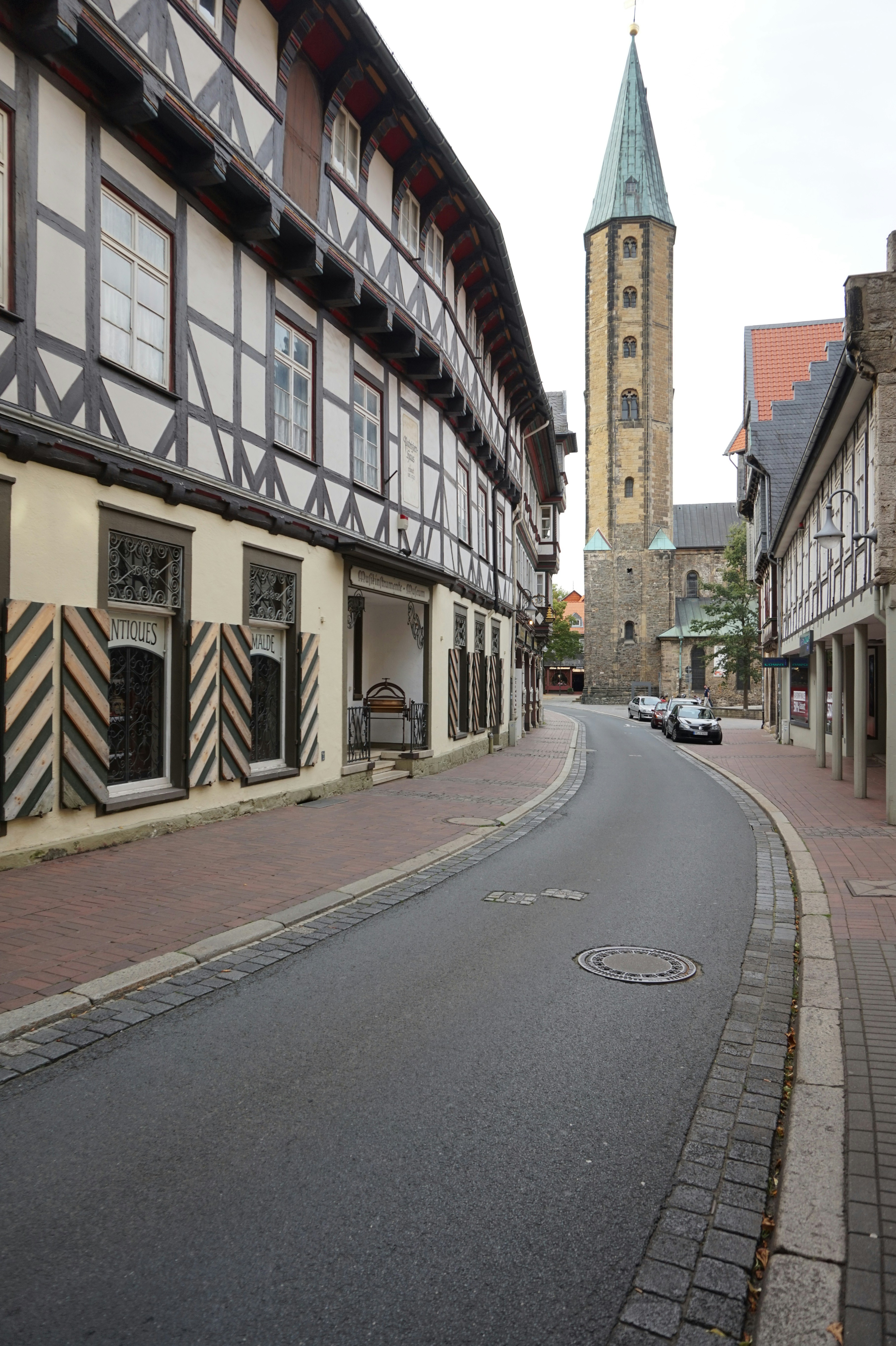 a street with a clock tower in the background