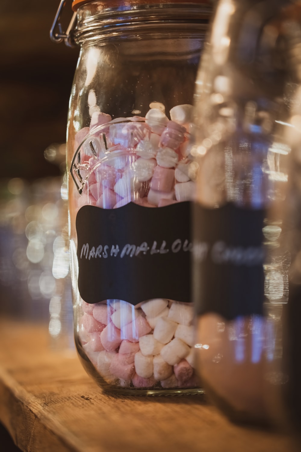 a jar filled with marshmallows sitting on top of a wooden table