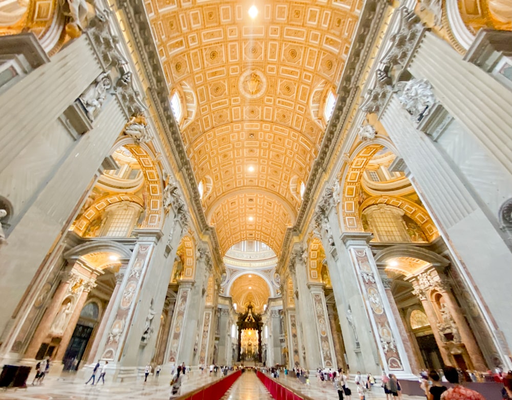 the ceiling of a large building with a red carpet