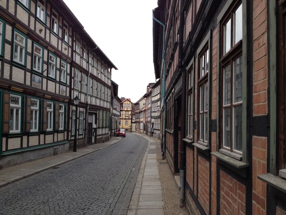 a cobblestone street lined with old buildings