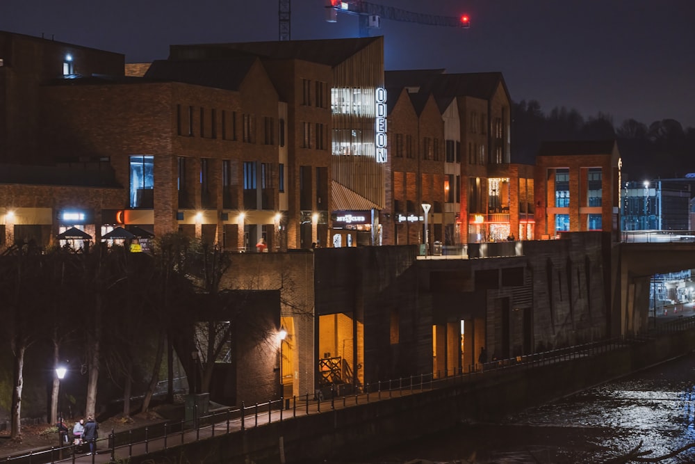 a city at night with a river running through it