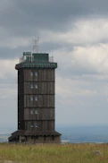 a tall tower sitting on top of a lush green field