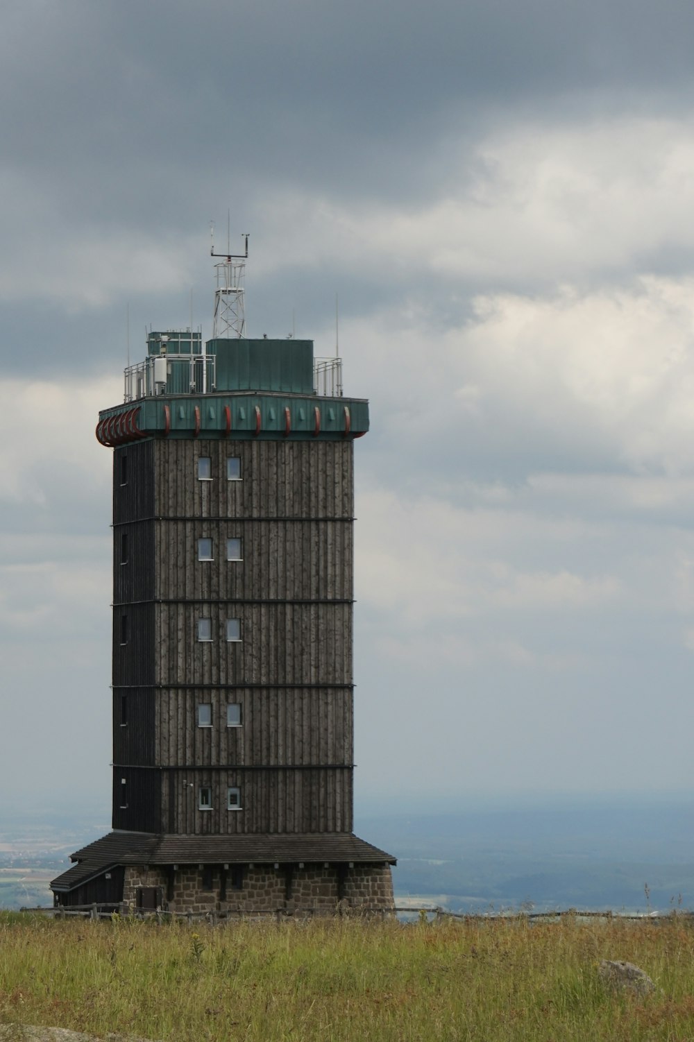 a tall tower sitting on top of a lush green field