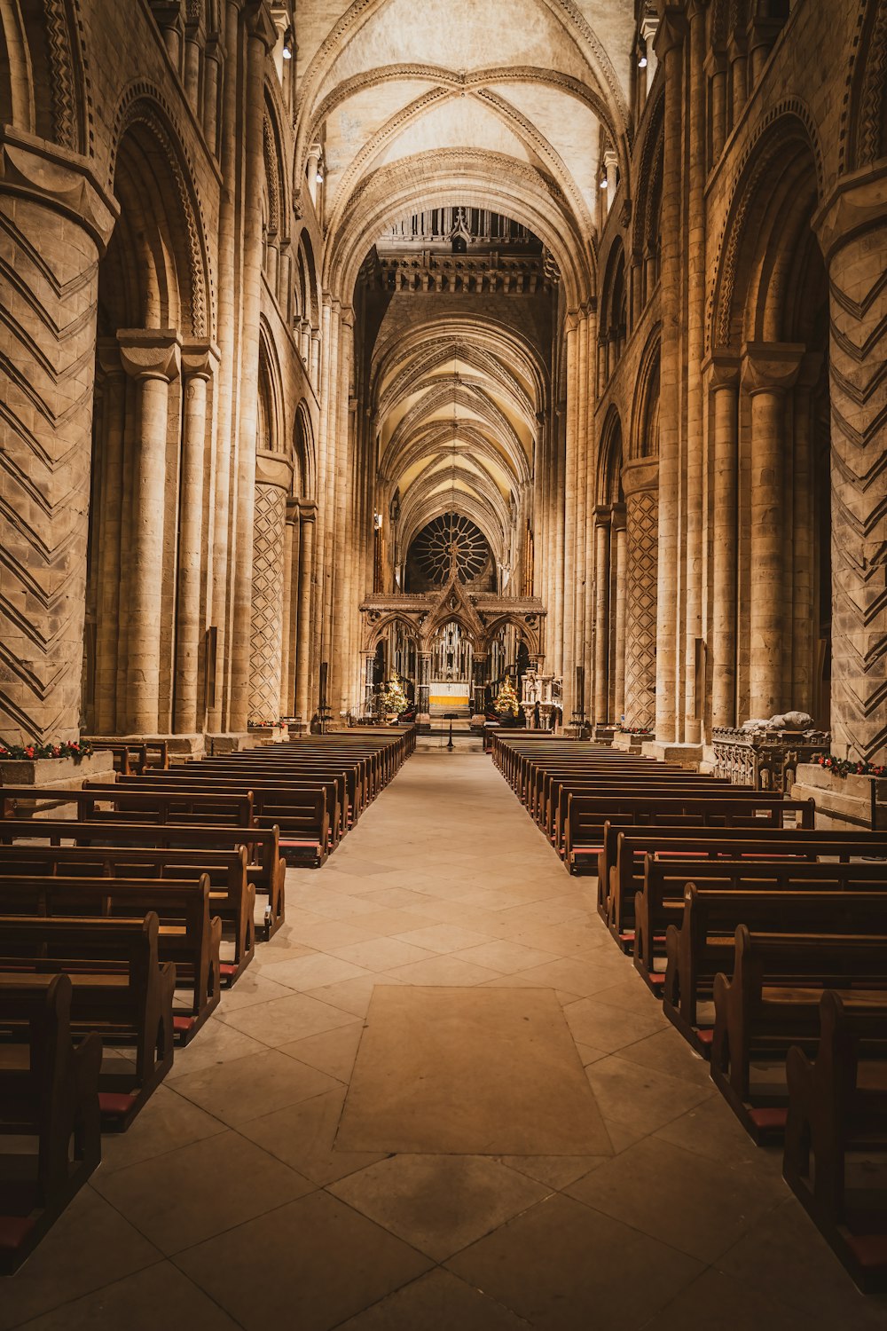 a church with rows of pews and a stone floor