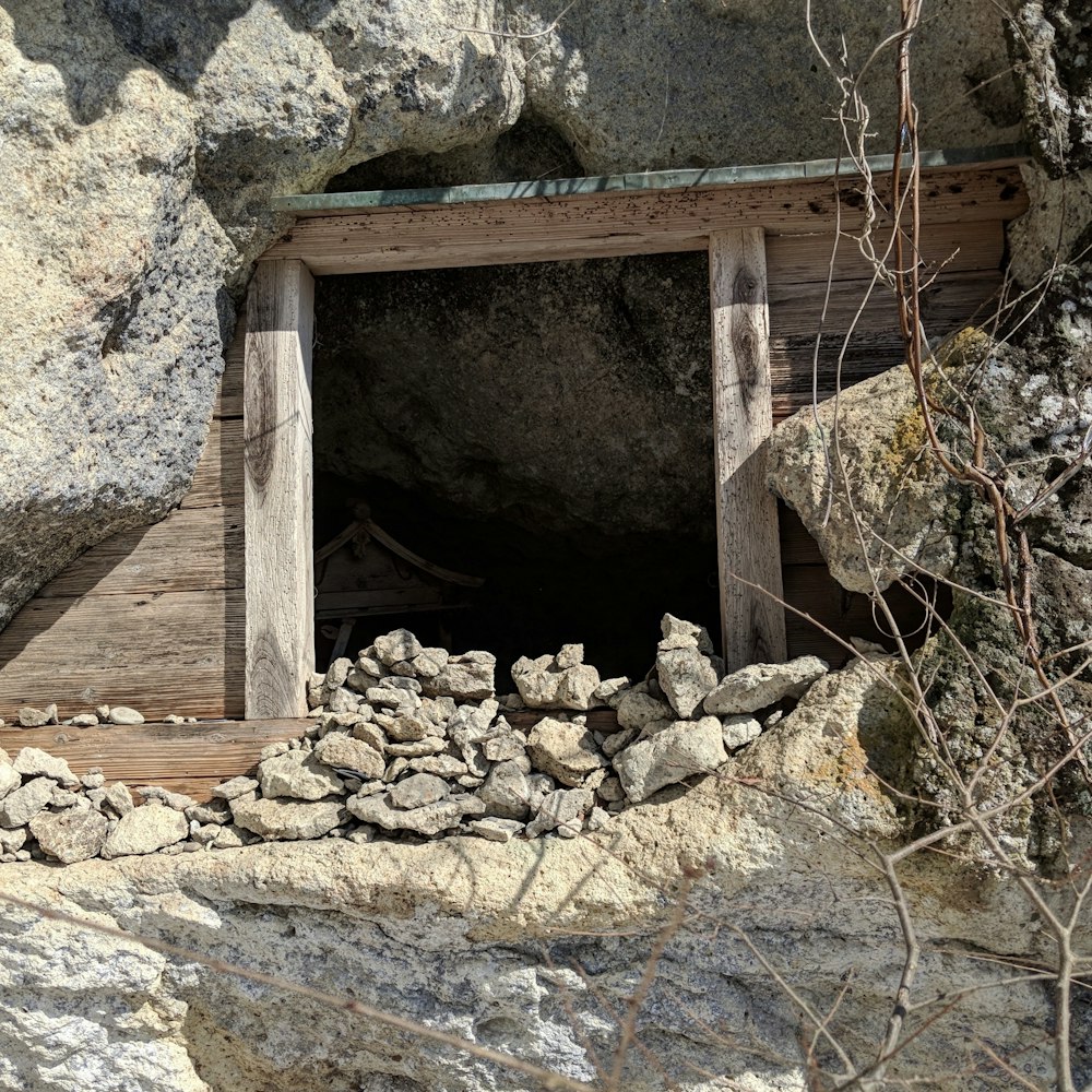 a cave with rocks and a wooden door