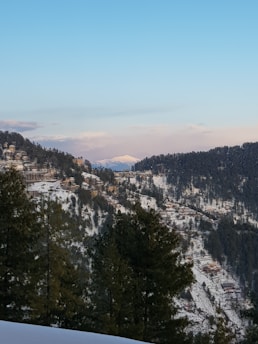 A peaceful mountain resort with snow-capped peaks in the background.