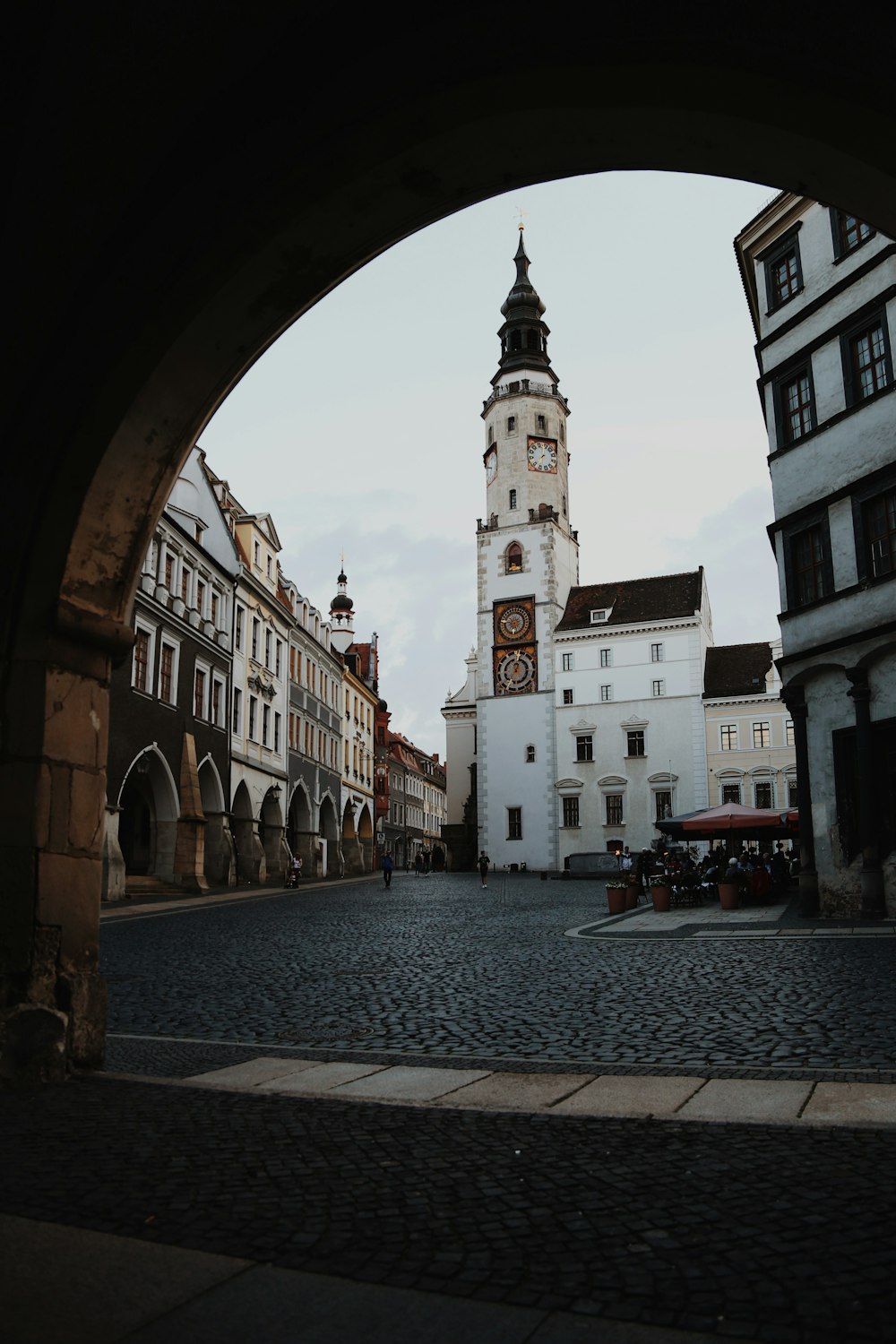 a clock tower towering over a city street