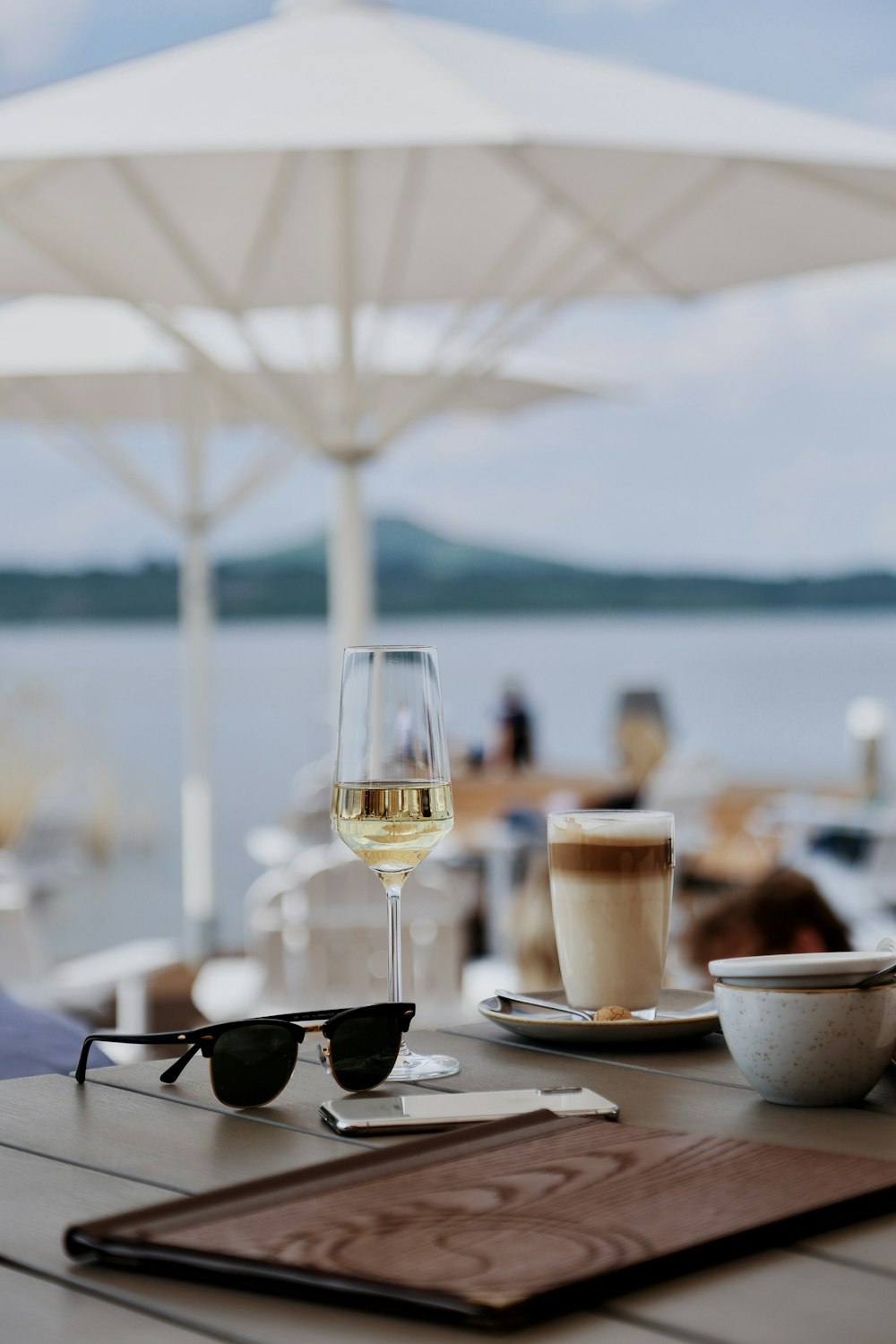 a glass of wine sitting on top of a wooden table