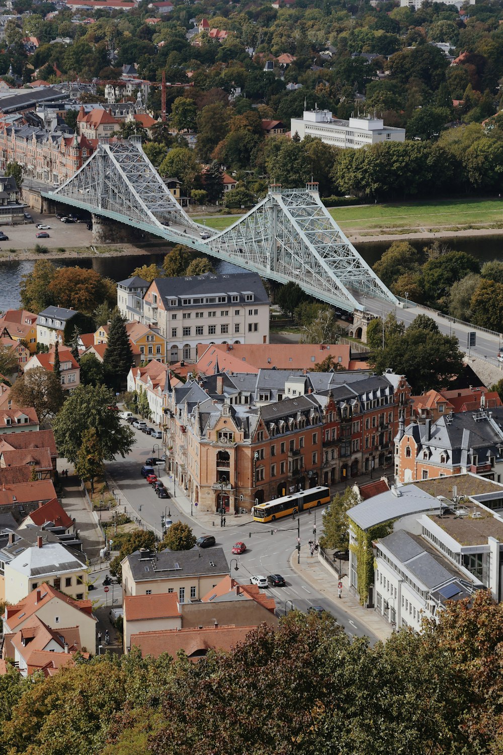 an aerial view of a city with a bridge in the background