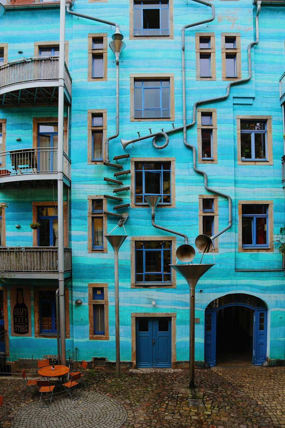 a blue building with a spiral staircase painted on it