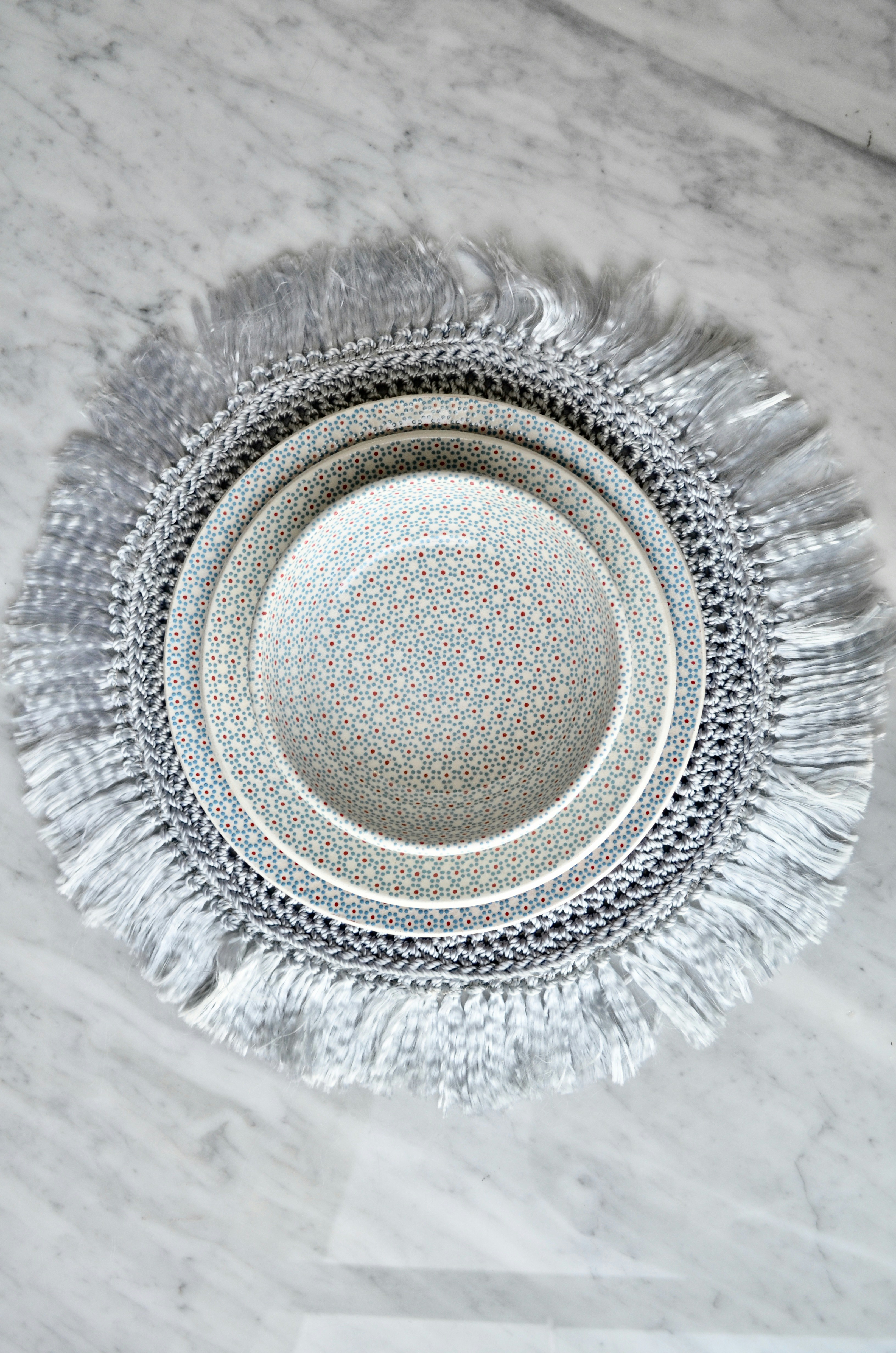 a white and silver plate on a marble table