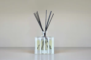 Multi-angle shots of a reed diffuser bottle showcasing the sleek design and subtle branding of auraluxe products.