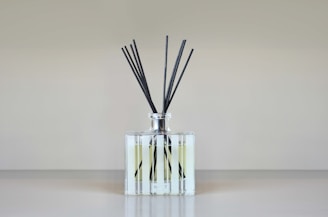 Activated carbon pellets derived from bamboo, displayed in a glass container under soft lighting.