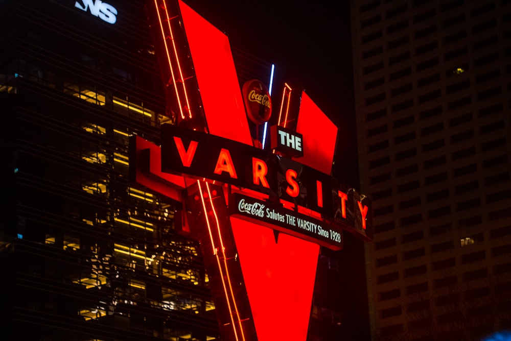 a very tall building with a very large v sign on it's side