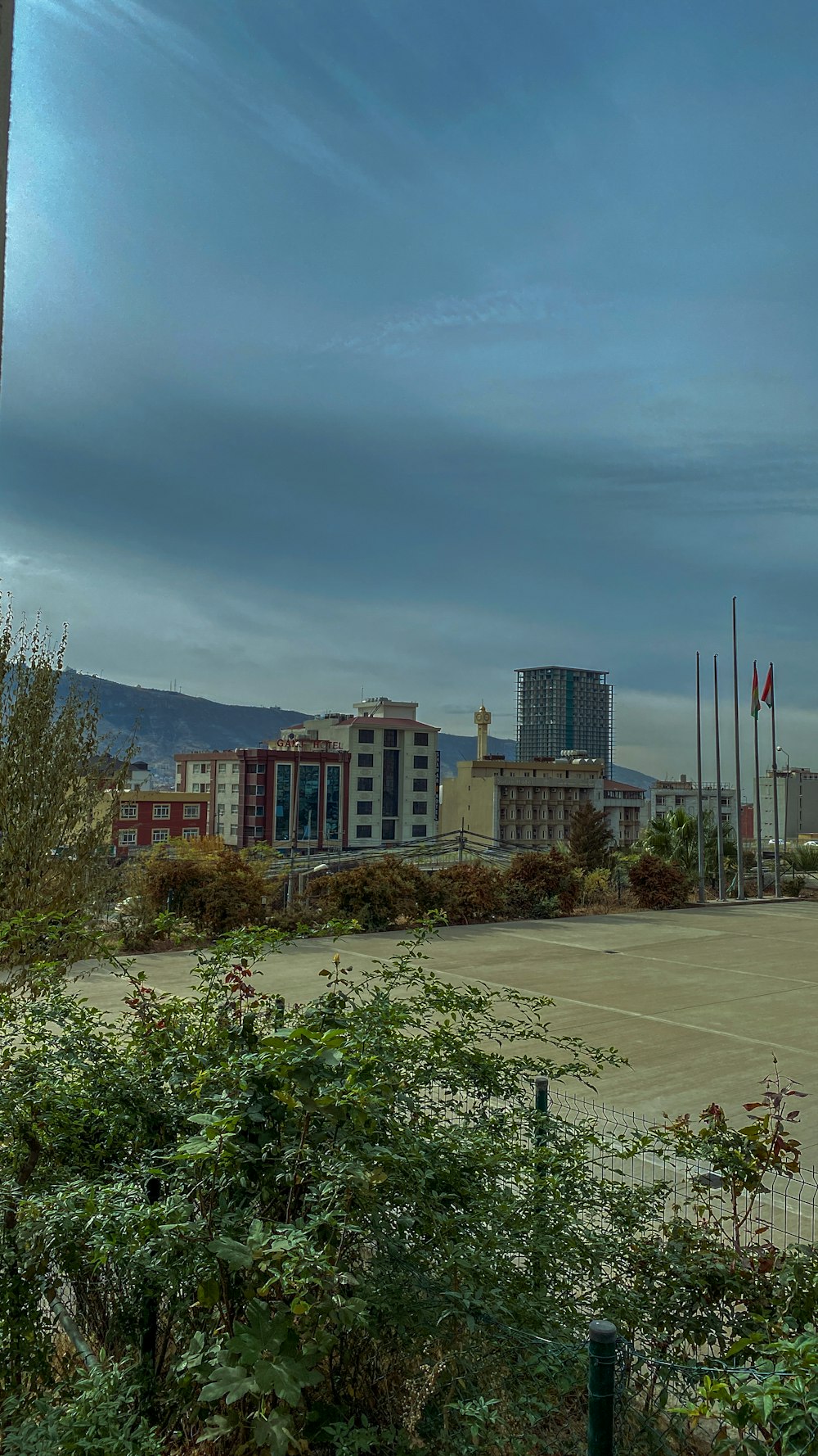 a parking lot with a clock tower in the background