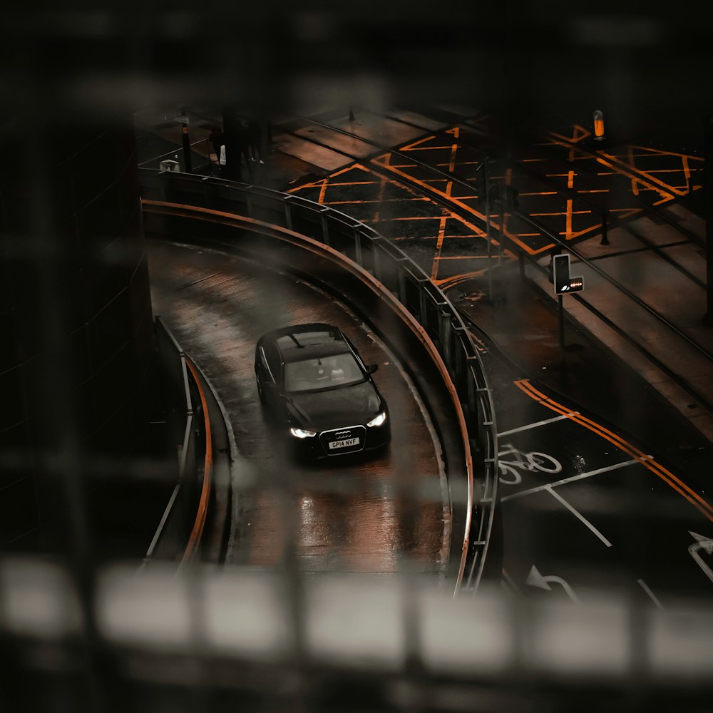 a car driving down a city street at night