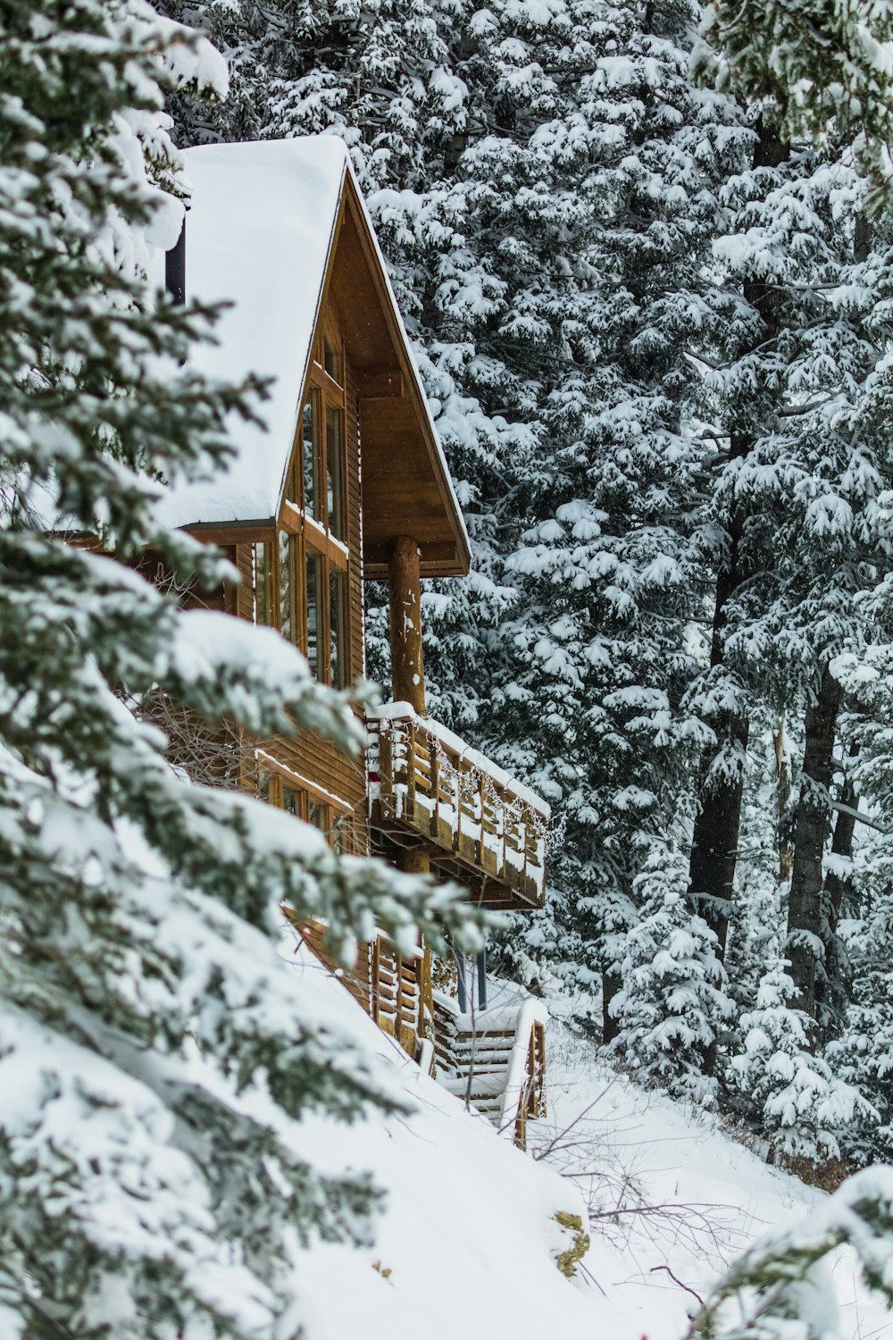 a cabin in the woods covered in snow