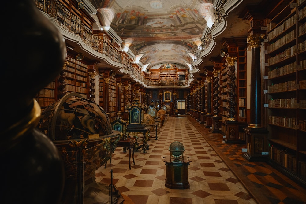 a long room with many bookshelves and a clock