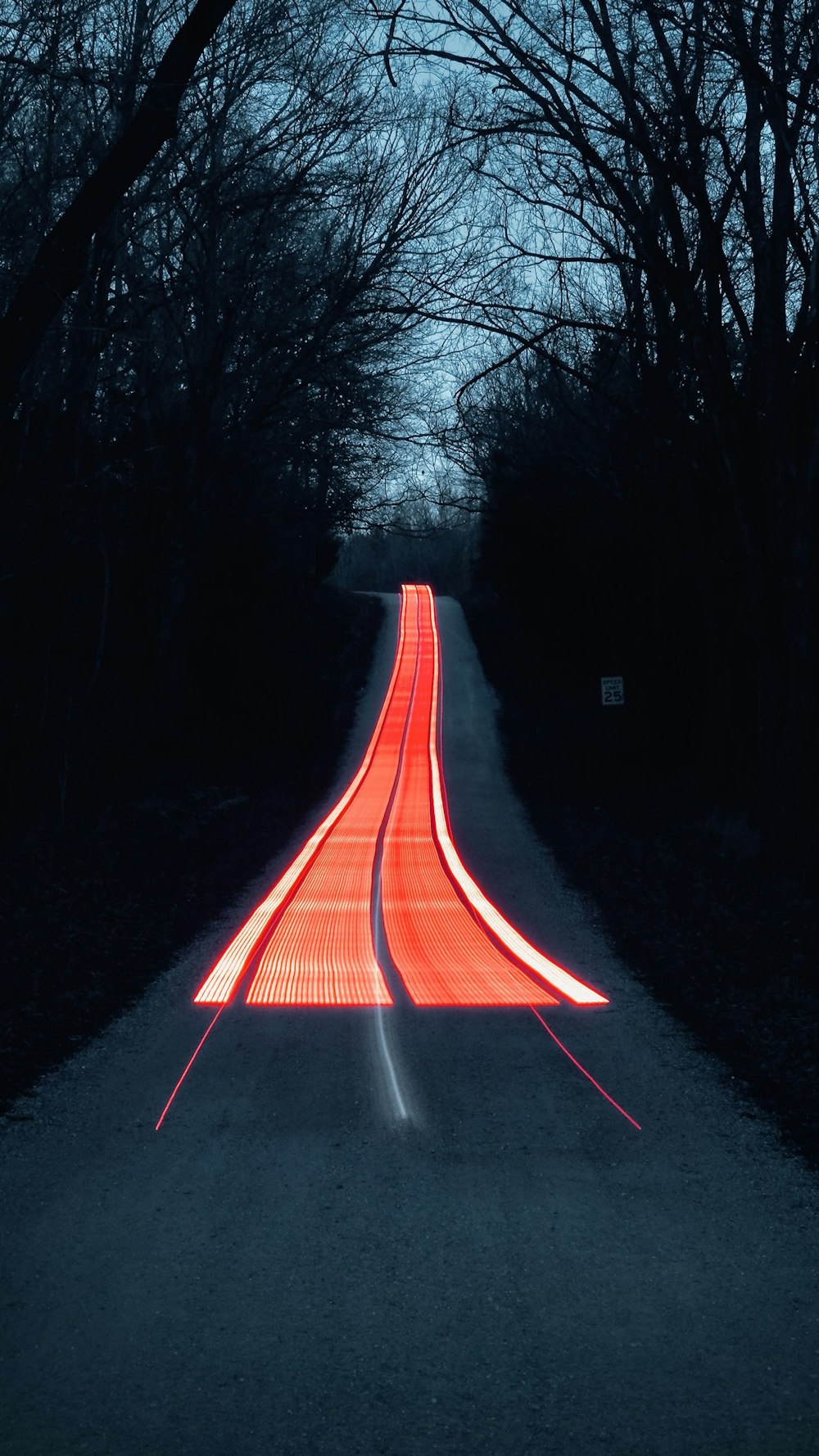 a long exposure photograph of a road at night