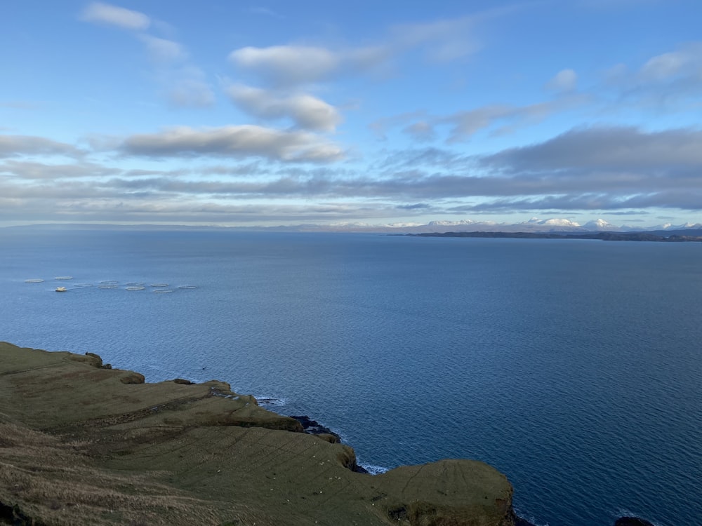 a large body of water sitting on the side of a hill