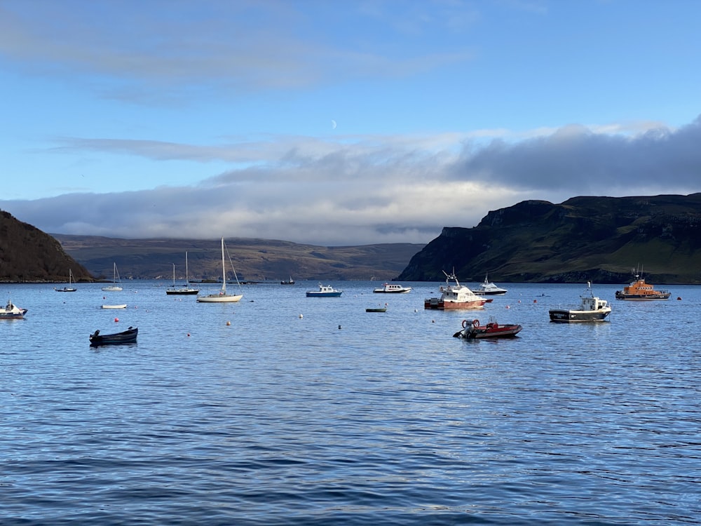 a group of boats floating on top of a large body of water