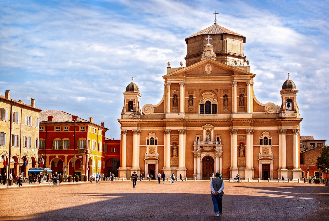 a person standing in front of a large building,